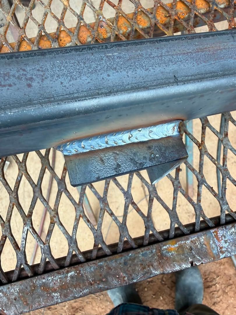Fresh weld bead joining a steel bar to an expanded-metal grate